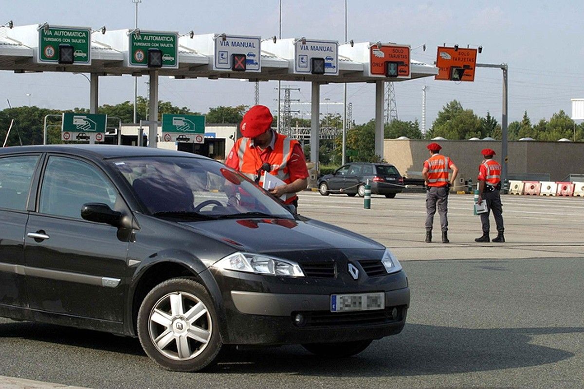 Foruzainak errepide batean autoen zirkulazioa kontrolatzen. NAFARROAKO GOBERNUA.