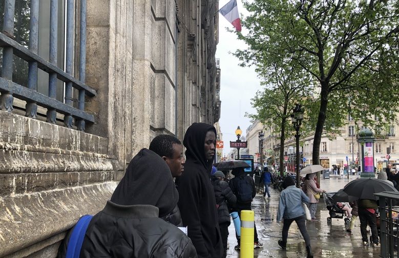 Parisko udaletxearen parean arratsaldero elkartzen diren immigranteetako batzuk.