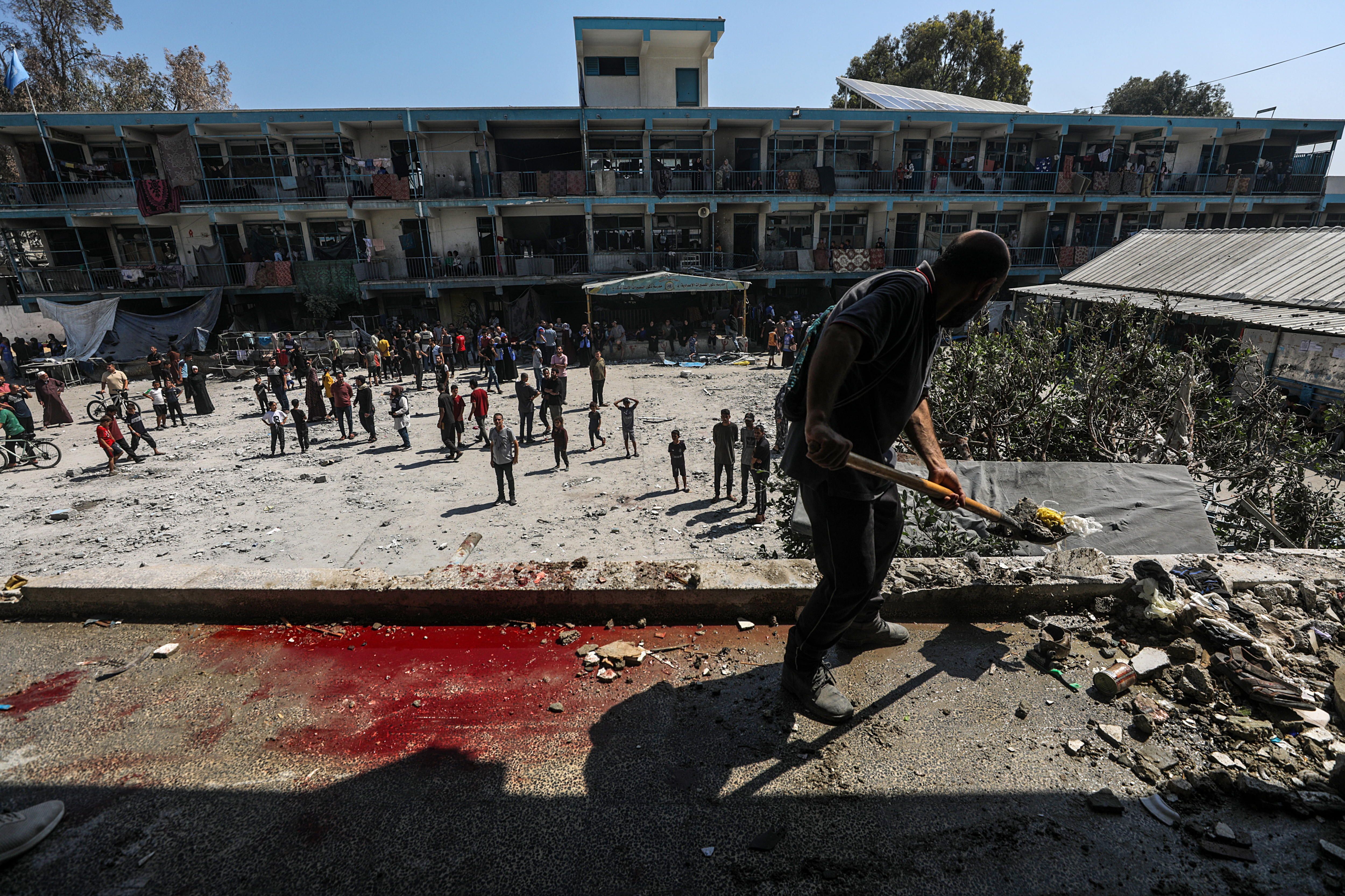 Palestinar batzuk UNRWAren eskolan, Al-Nuseiraten (Gaza), gaur, Israelgo armadak egindako erasoaren ondoren. MOHAMMED SABER / EFE